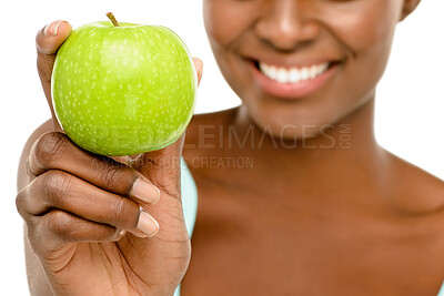 Buy stock photo Nutrition, studio and hand of black woman with apple for detox, wellness and benefits of natural food. Digestion, gut health and girl with smile, diet and balance with green fruit on white background