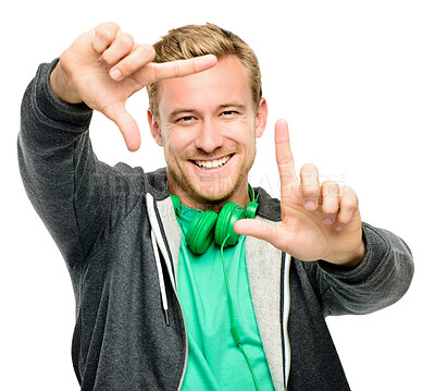 Buy stock photo Headphones, frame and portrait of man in studio smile for confidence, pride or positivity. Happy, finger and isolated person with gesture for photography, picture or perspective on white background