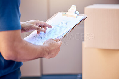 Buy stock photo Shot of a unrecognizable man using a clipboard while delivering outside