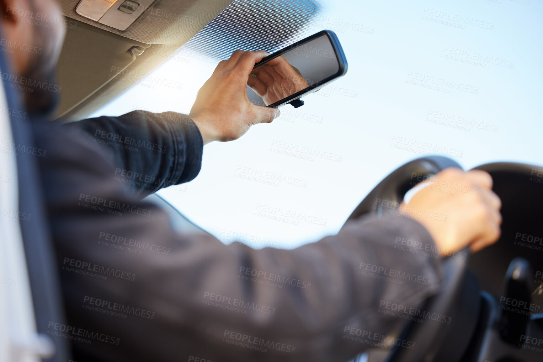 Buy stock photo Shot of a young man taking a selfie in his car