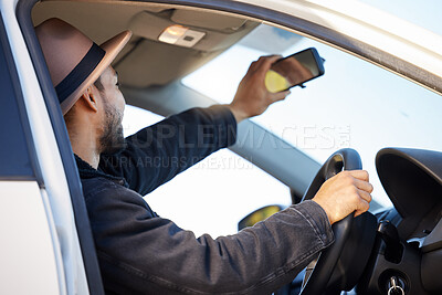 Buy stock photo Shot of a young man taking a selfie in his car