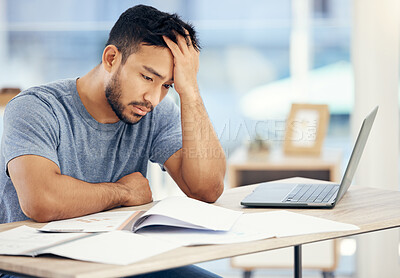 Buy stock photo Shot of a young businessman looking stressed in an office at work