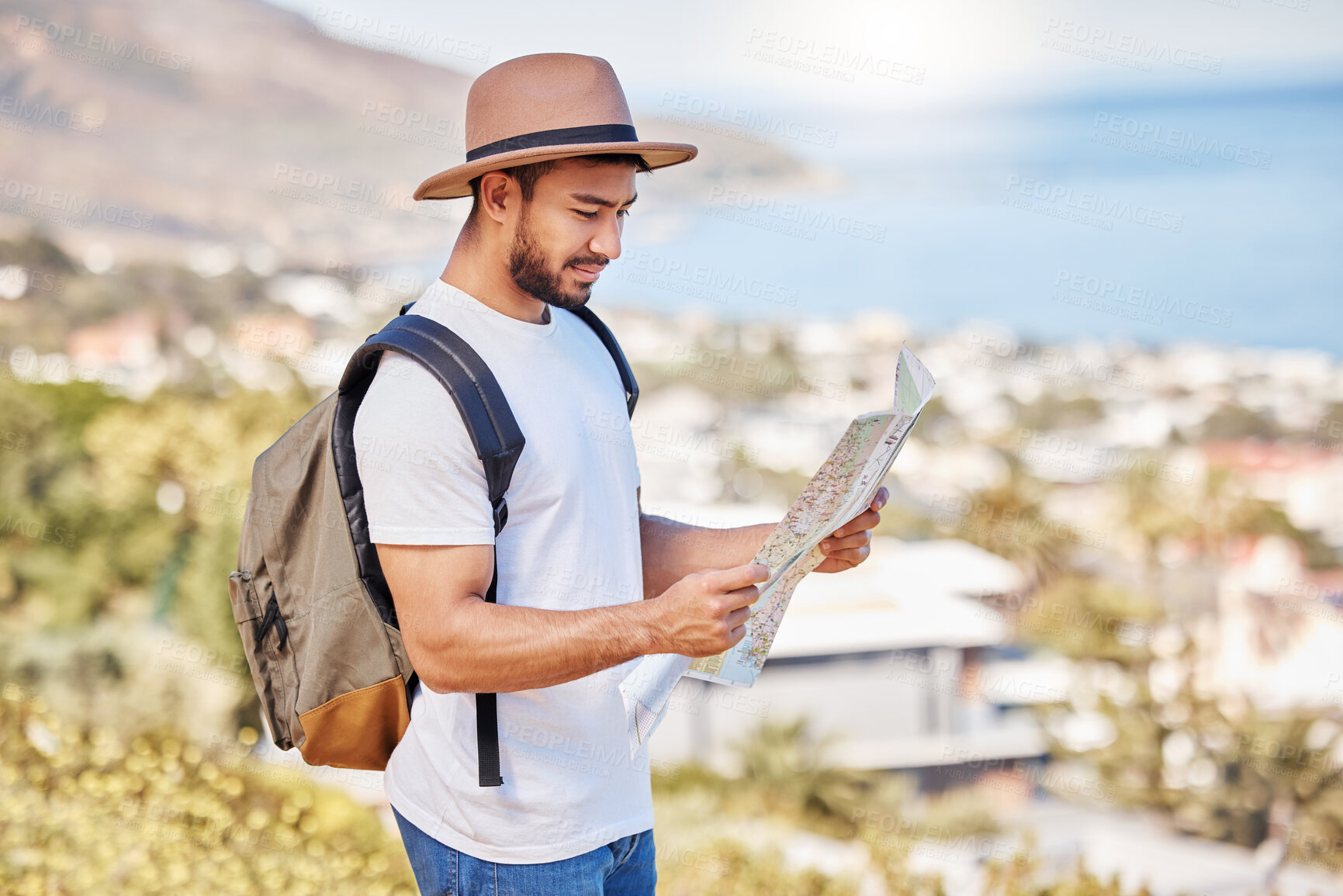 Buy stock photo Shot of a young man holding a map while exploring outdoors