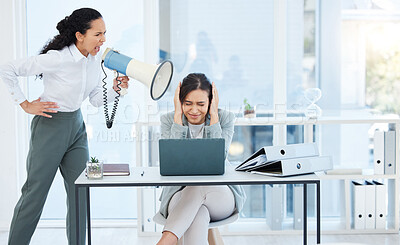 Buy stock photo Shot of a young businesswoman shouting at an employee through a megaphone in an office at work