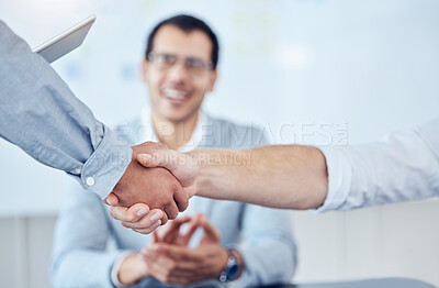 Buy stock photo Shot of two unrecognizable businesspeople shaking hands in a modern office