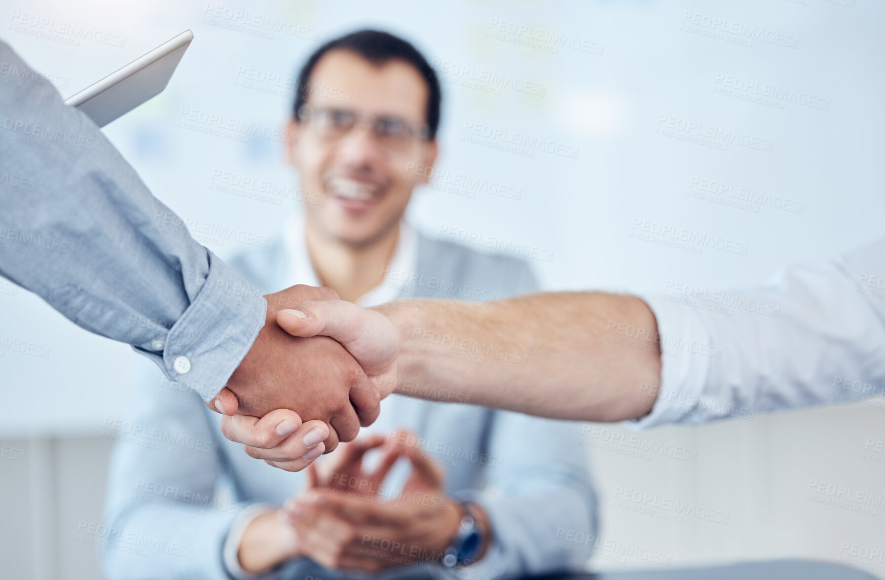 Buy stock photo Shot of two unrecognizable businesspeople shaking hands in a modern office