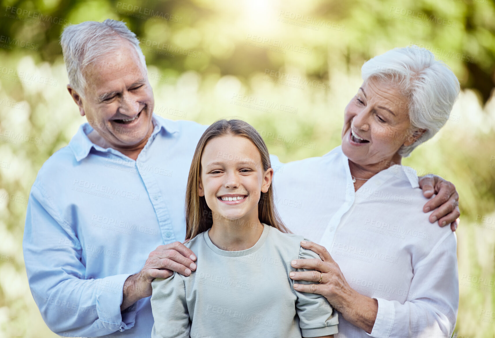 Buy stock photo Happy grandparents, grandchild and laughing with hug in nature for outdoor weekend, holiday or bonding. Grandpa, grandma and granddaughter with smile for family time, youth or childhood in nature