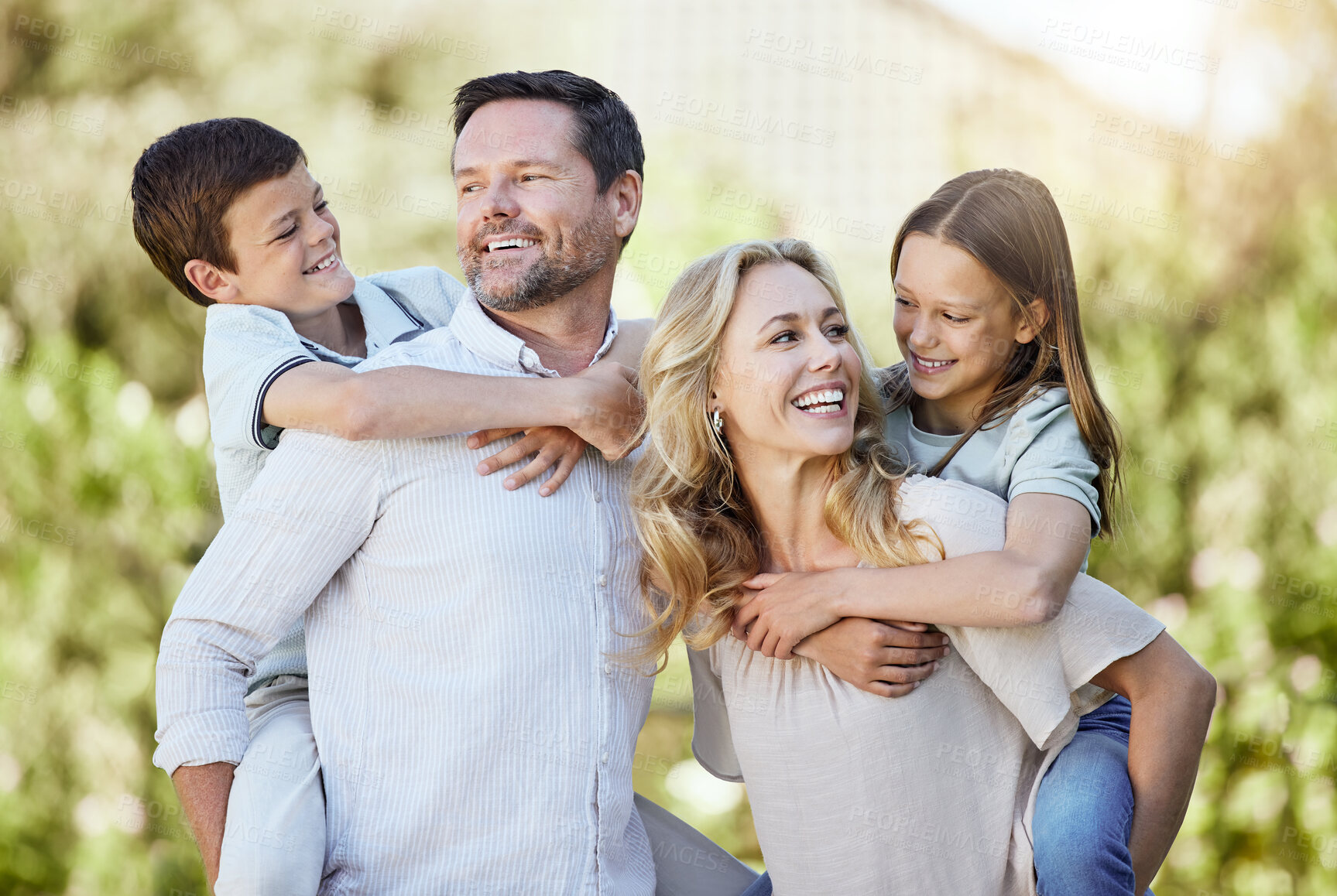 Buy stock photo Piggyback, happy and children with parents in nature for bonding, travel and adventure on vacation. Outdoor, family and kids with mother and father in park on holiday, getaway or weekend trip.