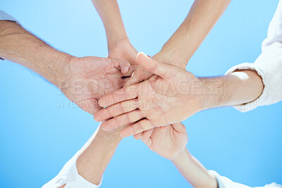Buy stock photo Cropped shot of a mixed-aged group stacking their hands on top of each other
