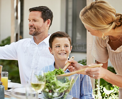 Buy stock photo Shot of a family enjoying a meal together