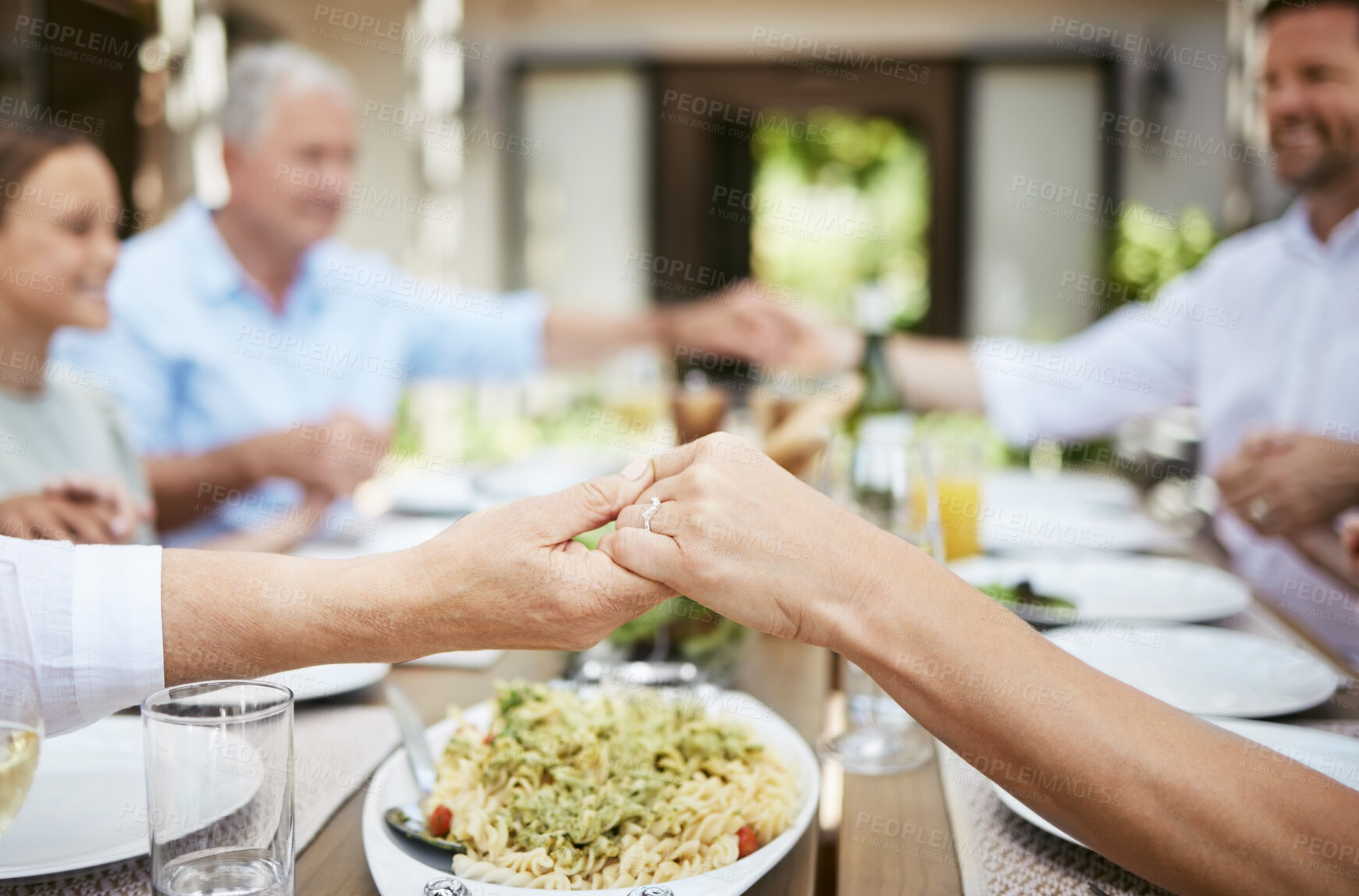 Buy stock photo Family, holding hands and praying for lunch, thanksgiving or holiday celebration at dinner table. Grace, food and people together for gratitude, blessing or closeup at social gathering event at home