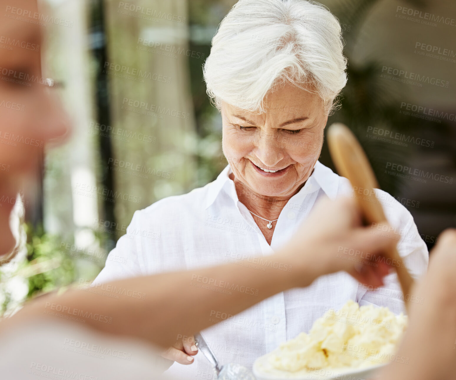 Buy stock photo Shot of a senior woman enjoying a meal with family