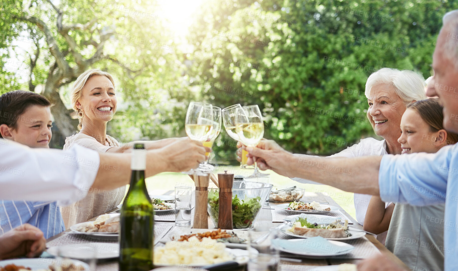 Buy stock photo Wine, cheers and food with family in garden for Thanksgiving celebration, festive holiday and brunch. Support, love and party with group of people and toast for nutrition, grateful and tradition