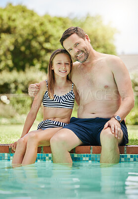 Buy stock photo Shot of a man and his daughter bonding by the poolside