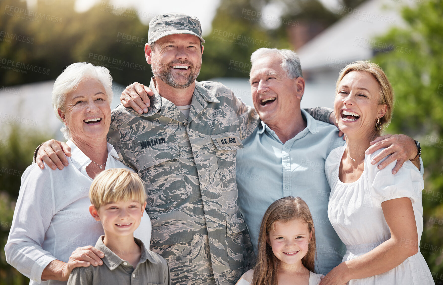 Buy stock photo Shot of returning soldier standing with his family outside