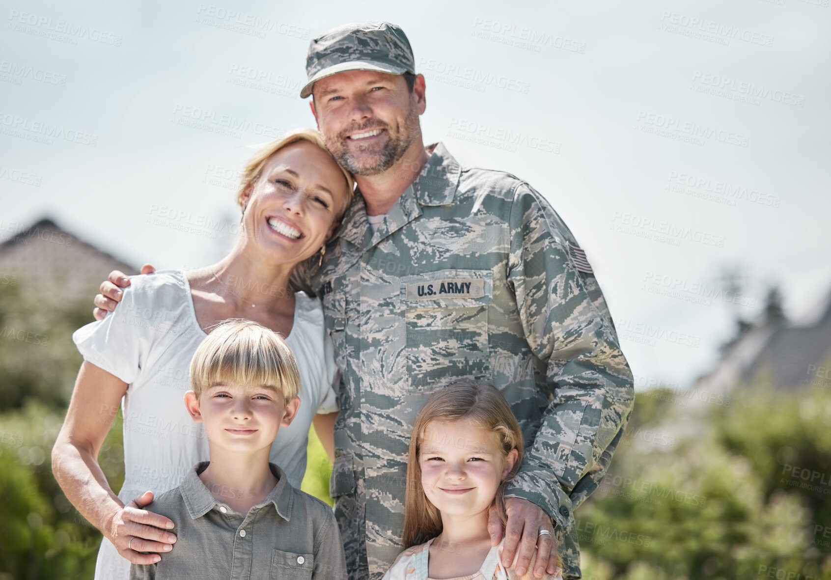 Buy stock photo Shot of returning soldier standing with his family outside