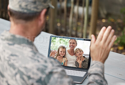 Buy stock photo Shot of a soldier on a video call with his family outside