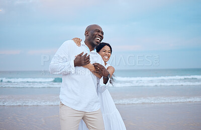 Buy stock photo Hug, honeymoon and black couple laughing at beach for love, trust or travel together on date. Smile, sea or happy people romantic anniversary for holiday, loyalty or marriage commitment in Mauritius