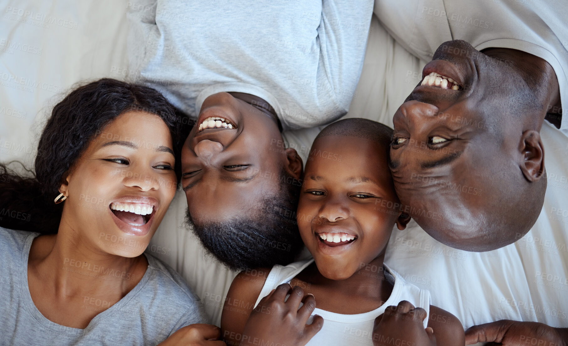 Buy stock photo Above, happy kids and black family laughing in bed with love, support or bonding together. Mother, father or African children siblings playing with smile in home to wake up in morning of lazy weekend