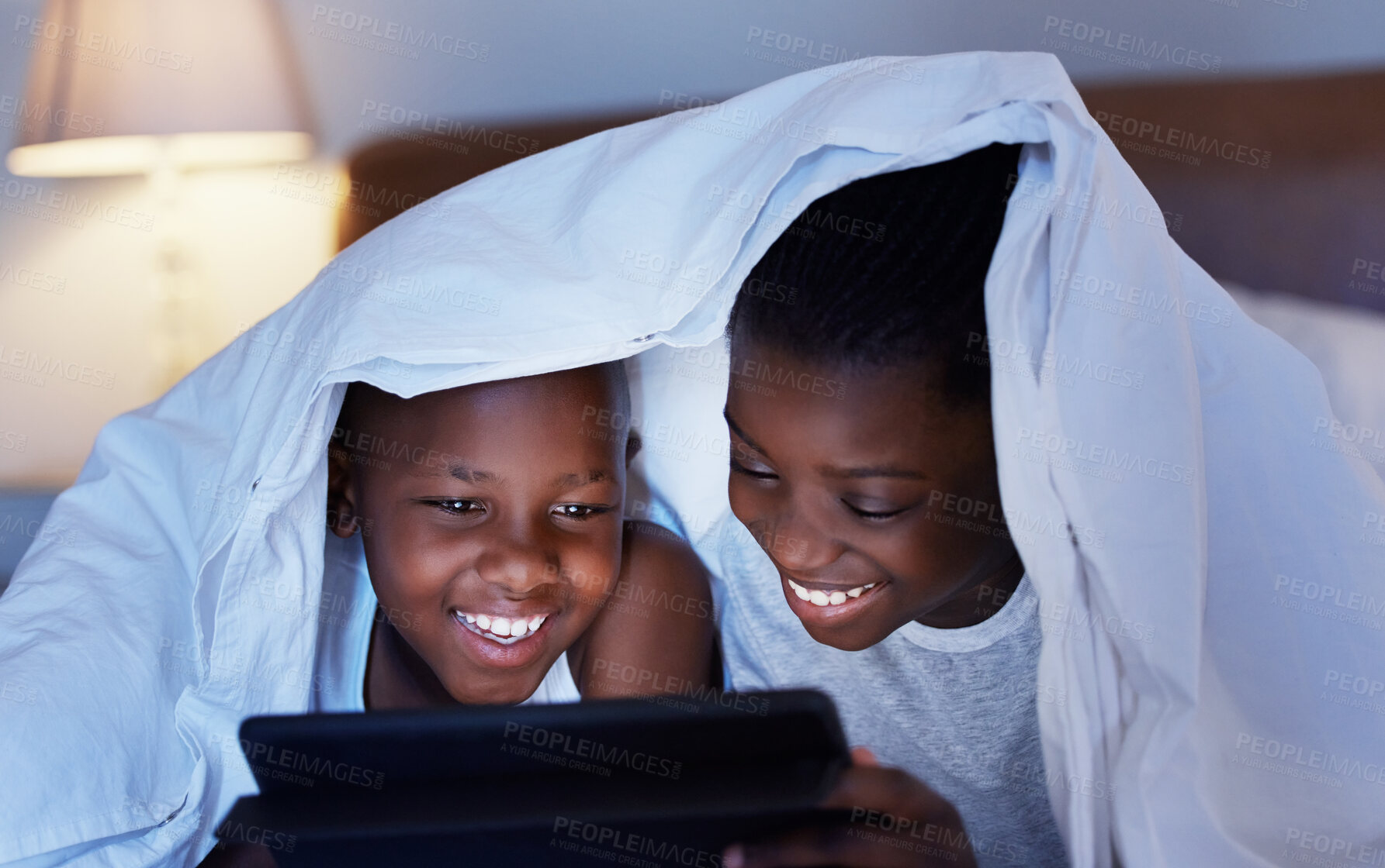 Buy stock photo Black family, night and siblings, tablet and playing with blanket, social media and online game. African kids, boy and girl in house, tech or internet with digital app, ebook and typing with children