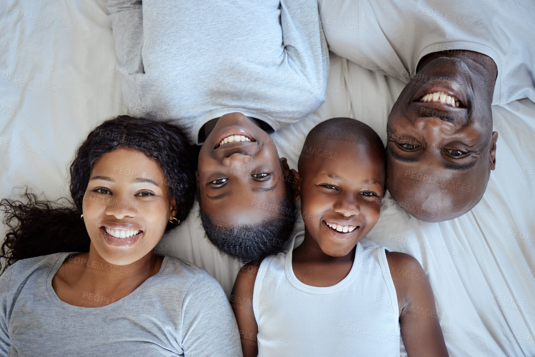 Buy stock photo Above, happy kids and black family in bed or portrait with love, support and bonding together. Mother, father or African children siblings with smile in home to wake up in lazy morning in Nigeria