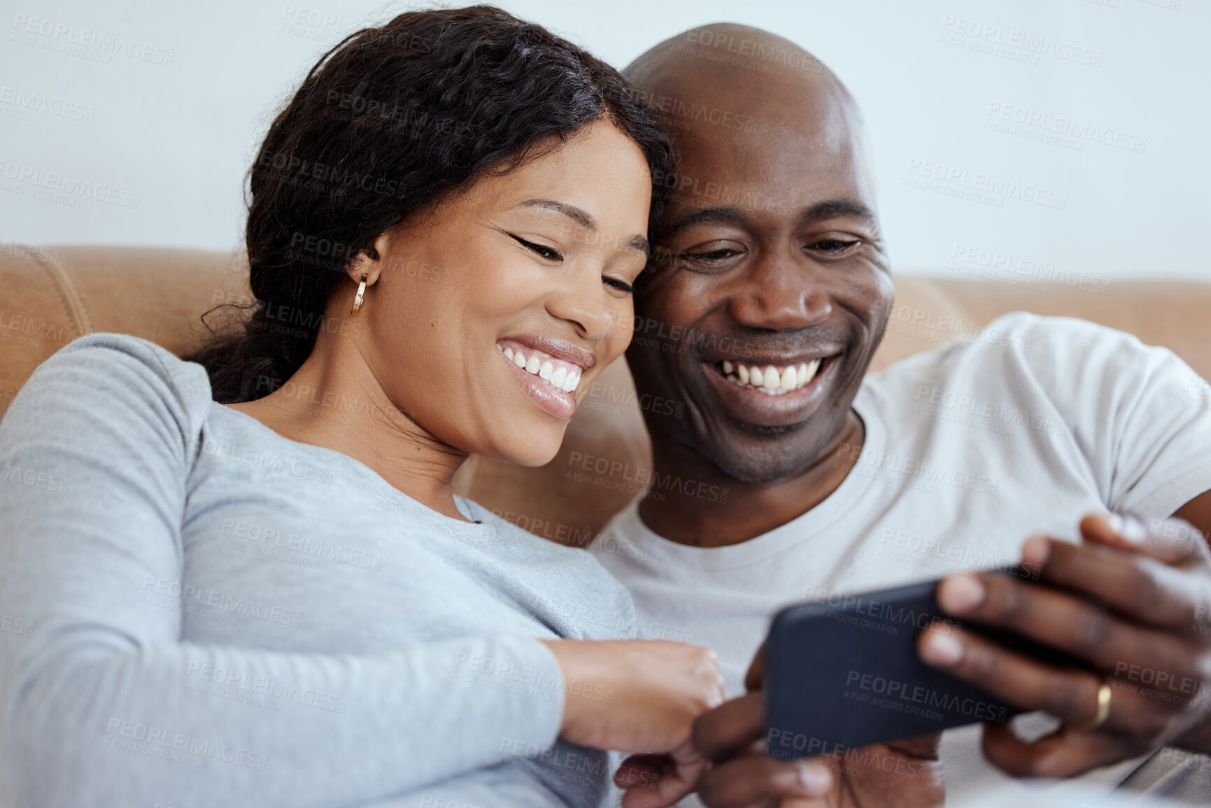 Buy stock photo Happy black couple, phone and relax in bed, streaming movie or watch show in home. Mobile, man and woman in bedroom for online shopping, credit score and account payment for banking app or purchase