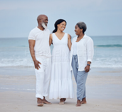 Buy stock photo Shot of a mature couple enjoying time with their daughter at the beach