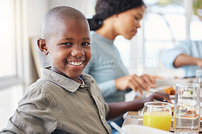 Buy stock photo Shot of a little boy sitting at a tablet with his family at home