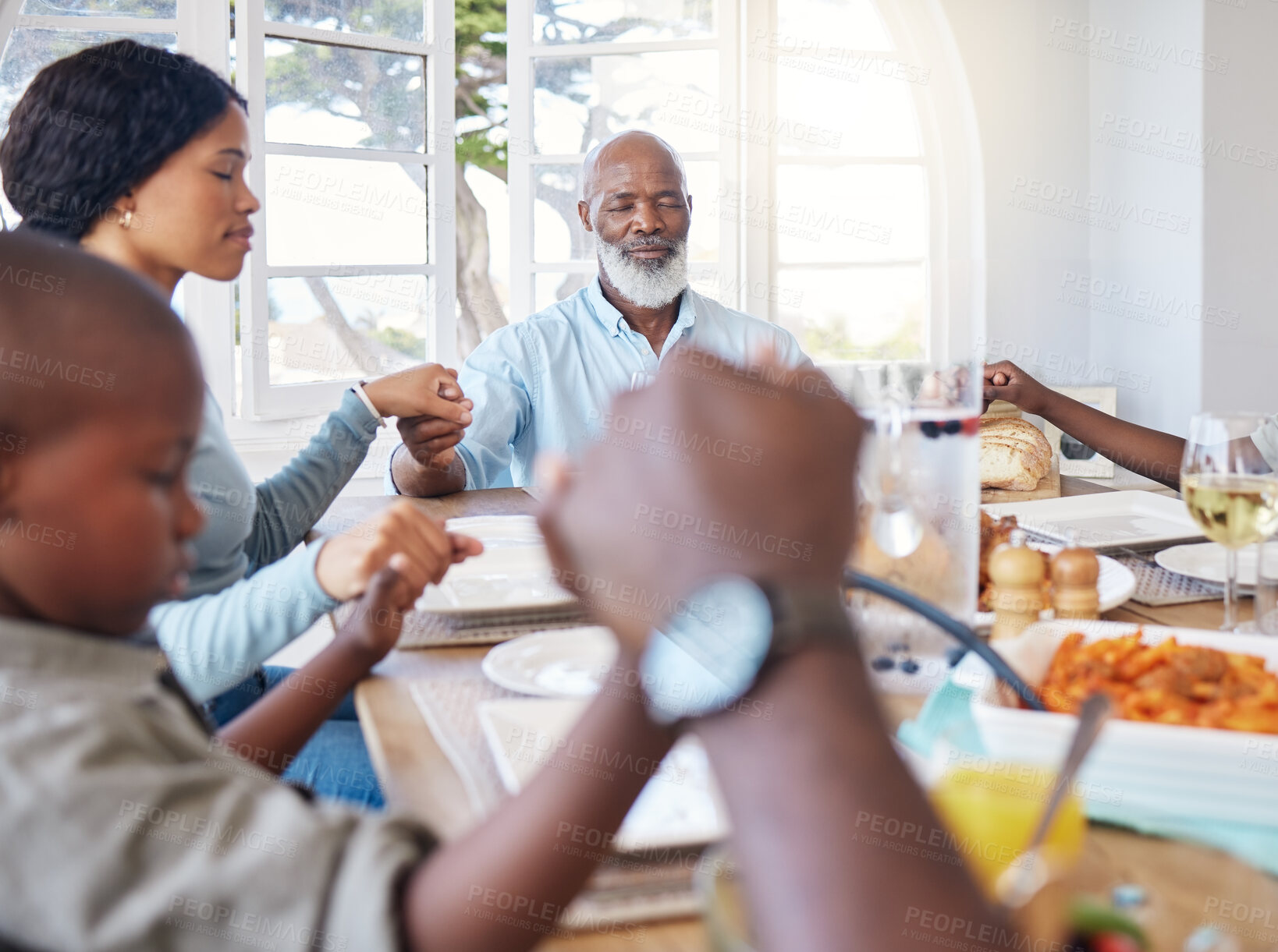 Buy stock photo Grandpa, black family or holding hands to pray for feast, gratitude or holiday brunch in home. Group, support or people at table together for sharing super, lunch or food in house for thanks or grace