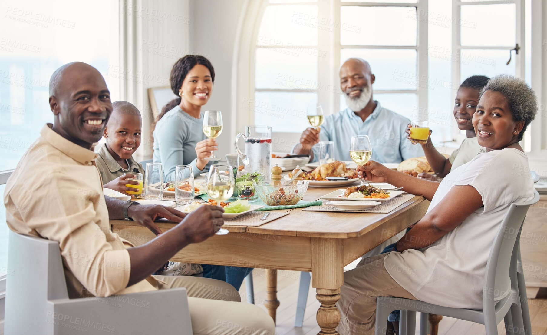 Buy stock photo Cheers, portrait and food with black family in home for Thanksgiving celebration, festive holiday and brunch. Support, love and party with people and lunch for nutrition, grateful and tradition