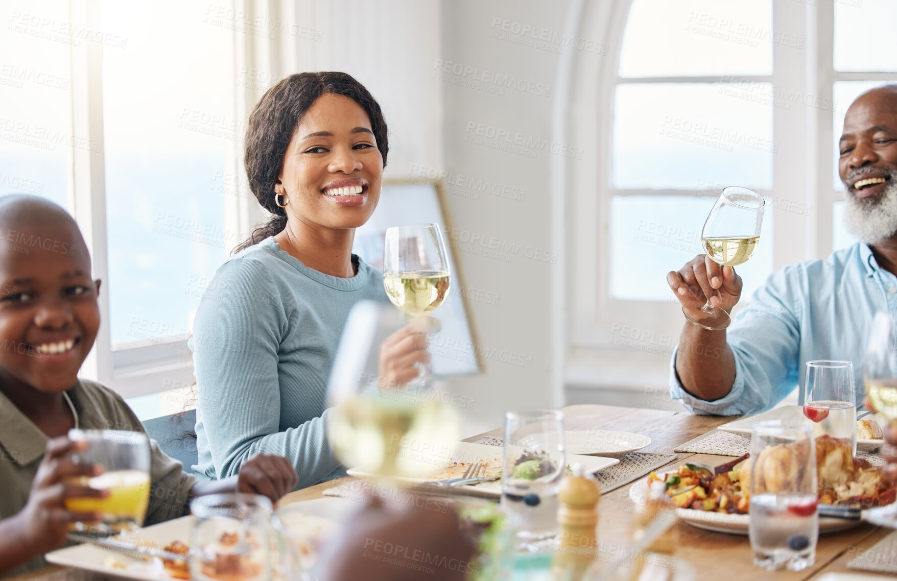 Buy stock photo Cheers, lunch and food with black family in home for Thanksgiving celebration, festive holiday and brunch. Support, love and party with people and toast for nutrition, grateful and tradition