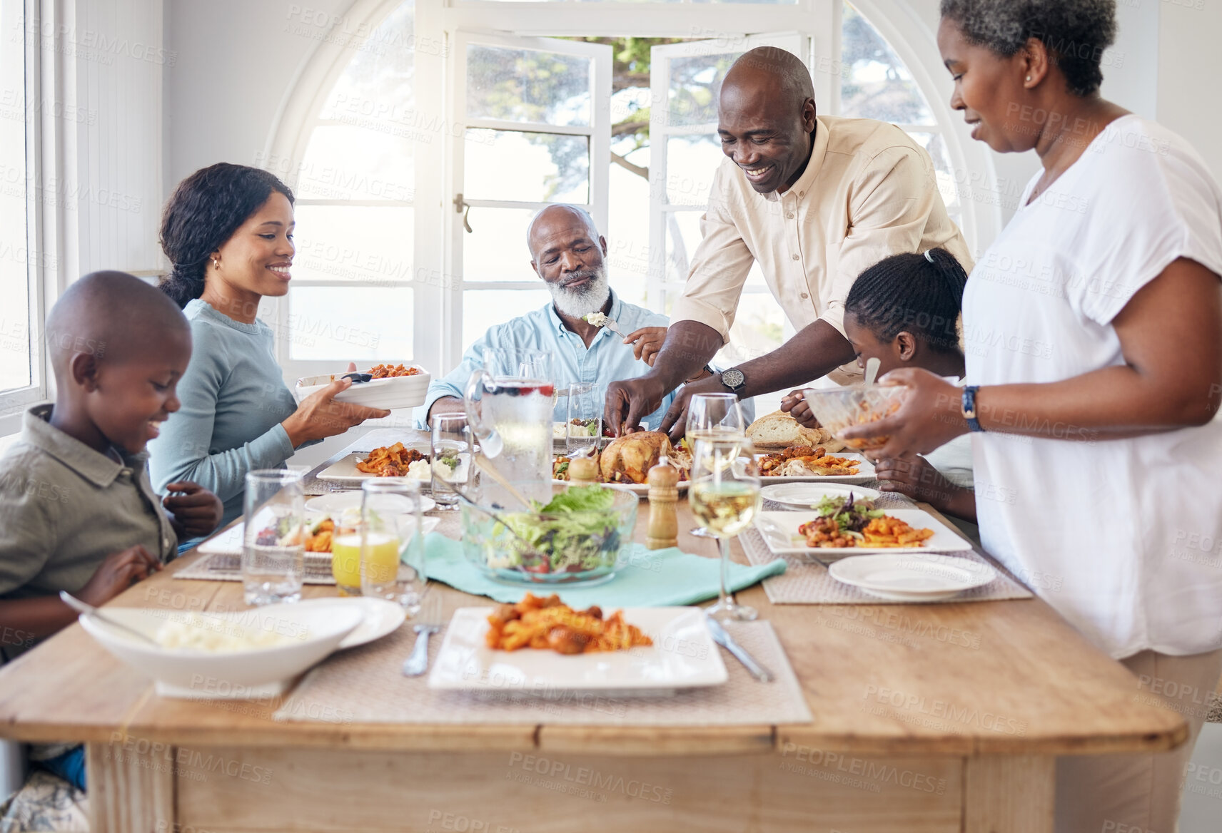 Buy stock photo Chicken, help and food with black family in home for Thanksgiving celebration, festive holiday and brunch. Support, love and party with people and lunch for nutrition, grateful and tradition event