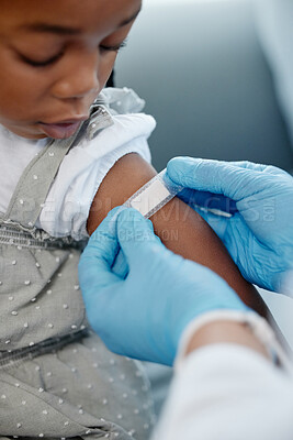 Buy stock photo Closeup shot of an unrecognisable doctor applying a plaster to a little girl's arm after an injection