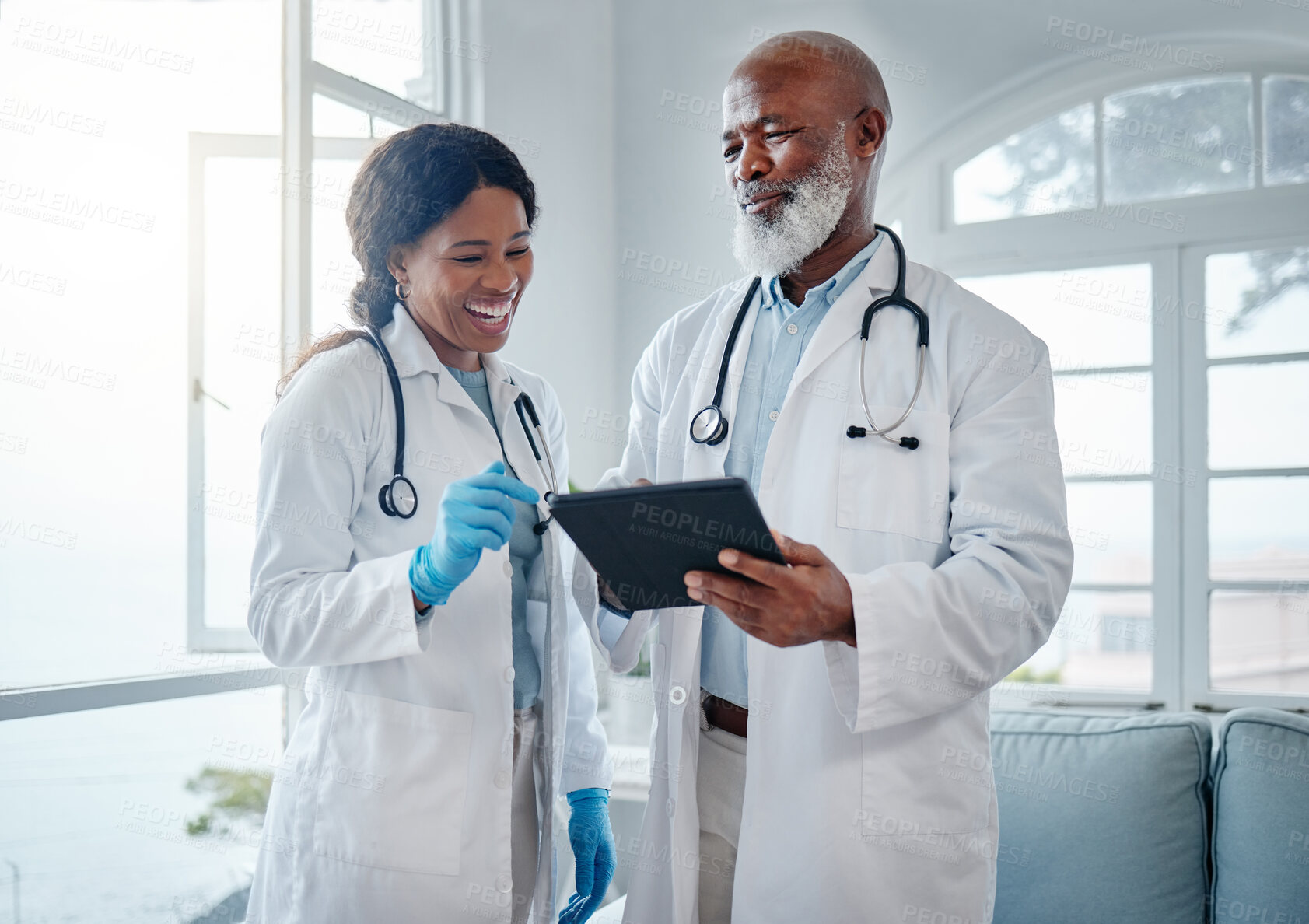 Buy stock photo African doctors, teamwork and smile with tablet, comic or conversation for team building in hospital. Senior black man, woman and medical discussion with digital touchscreen, social media and clinic