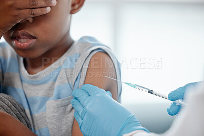 Buy stock photo Shot of a little boy looking scared while getting an injection on his arm from a doctor