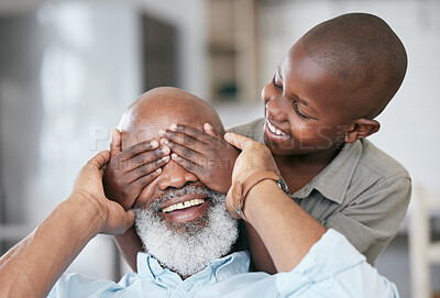 Buy stock photo Shot of a boy and his grandpa bonding at home