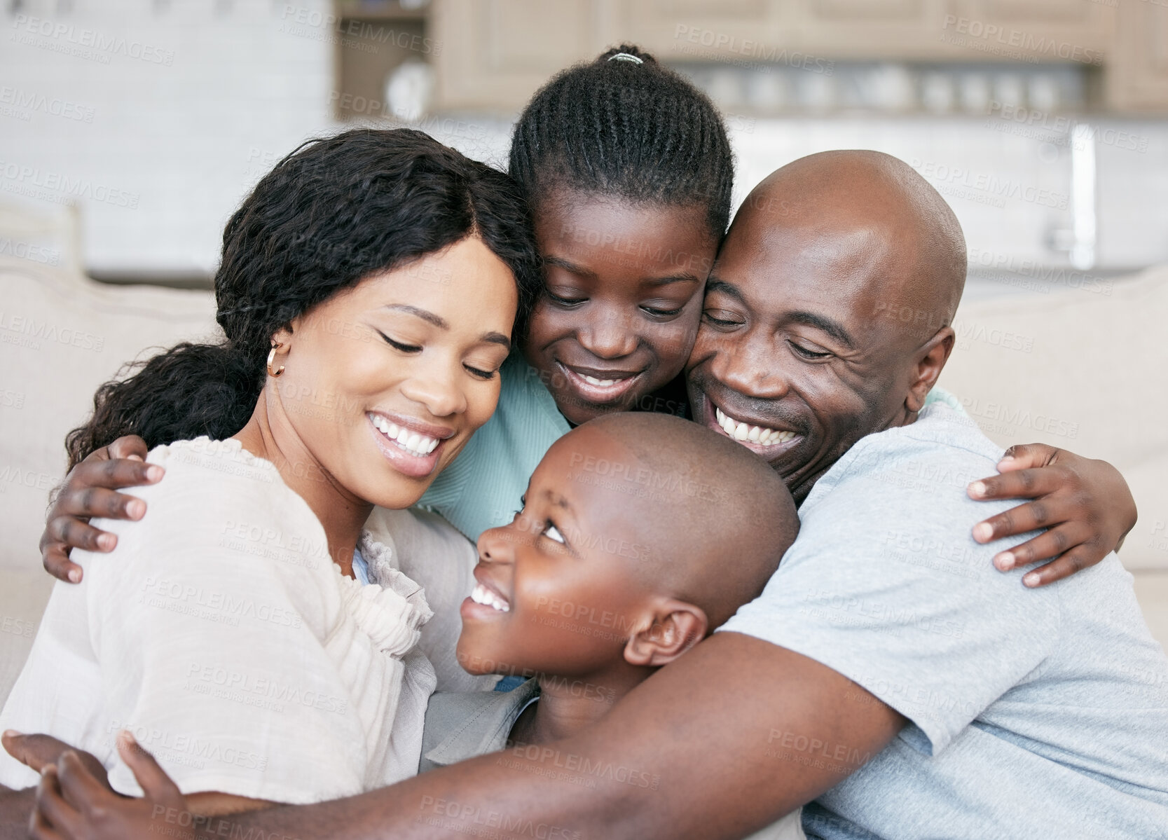 Buy stock photo Parents, kids and happy at home on hug in couch for bonding, fun and support with love. People, black family and smile in living room on sofa with unity, trust and care for memories and childcare