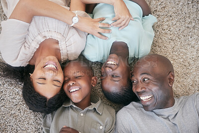 Buy stock photo Shot of a family laying on the floor at home