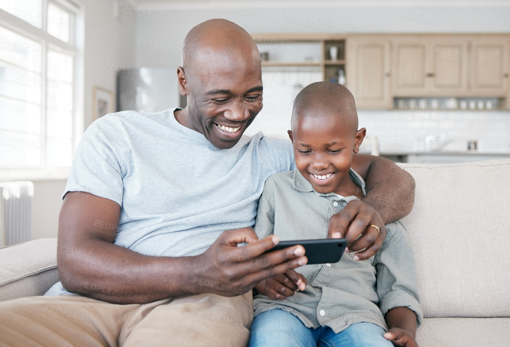 Buy stock photo Black people, dad and happy with boy on smartphone in sofa at home for streaming cartoons and games. Parent, kid and smile or laugh on couch in living room with entertainment for child development