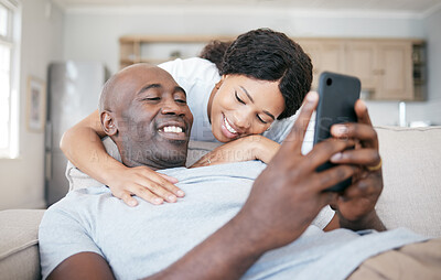 Buy stock photo Shot of a couple bonding on the sofa at home