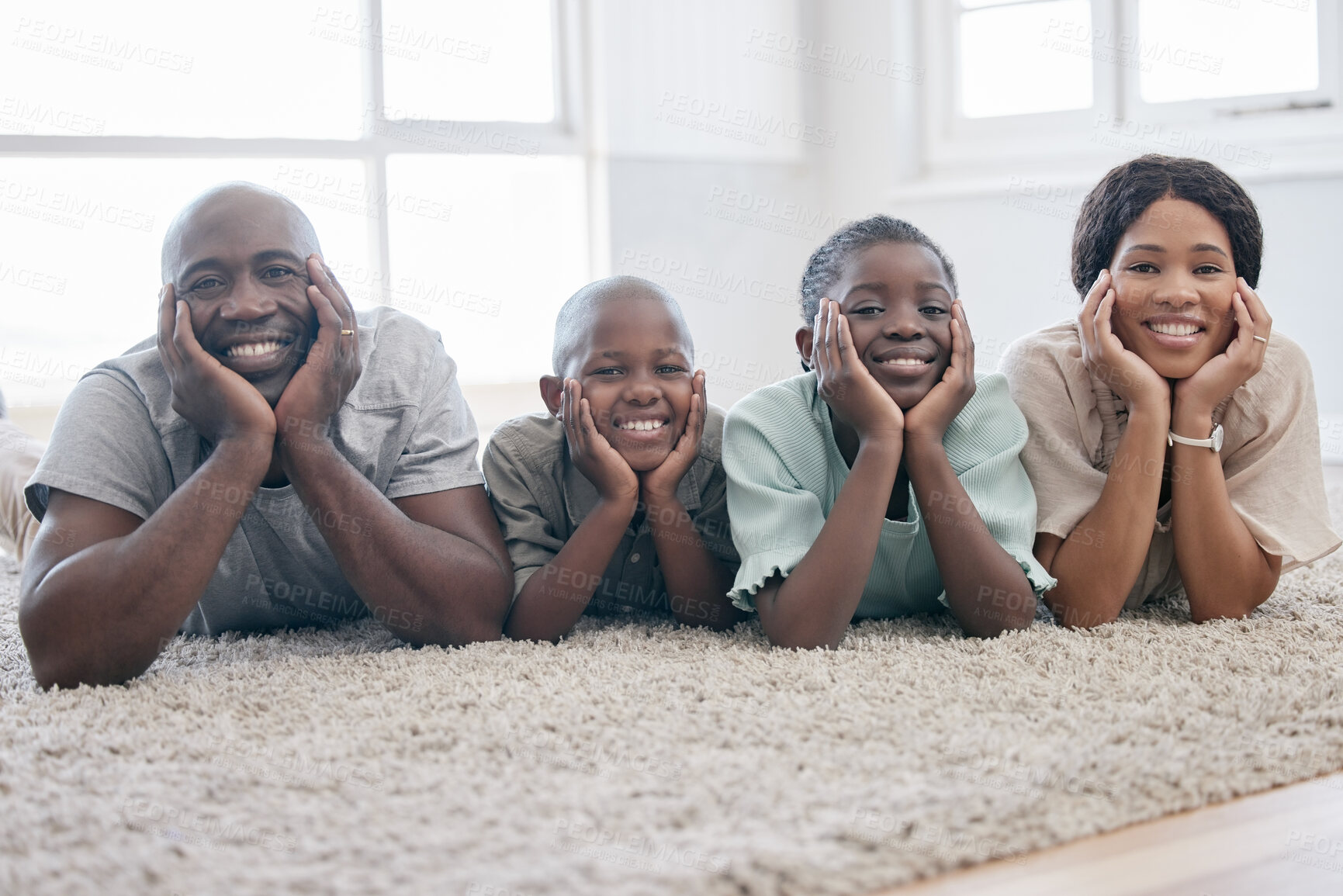 Buy stock photo Shot of a family laying on the floor and bonding at home