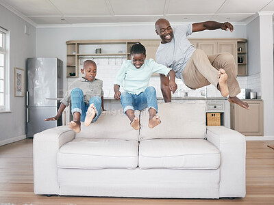 Buy stock photo Shot of a family jumping on to the sofa at home