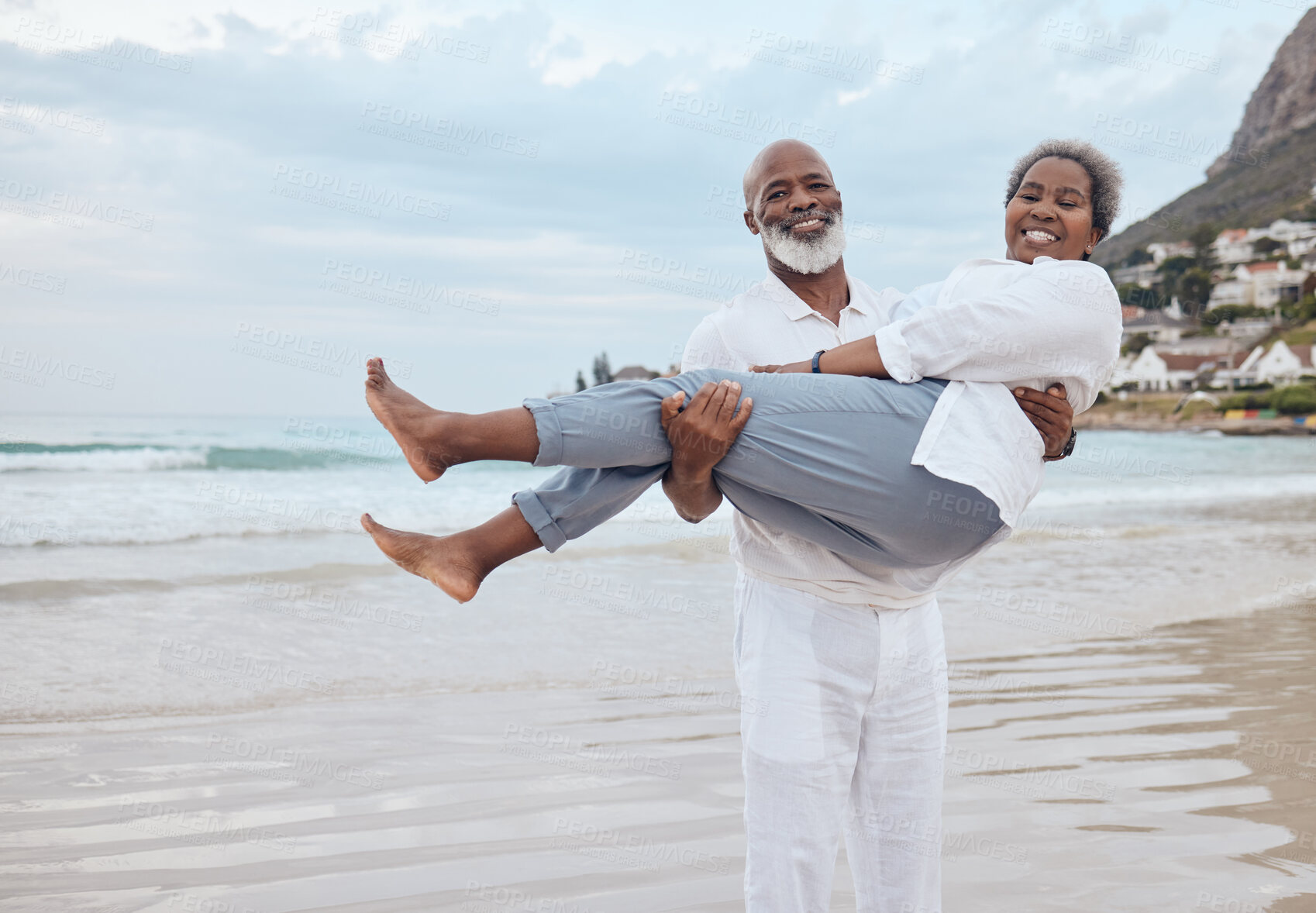 Buy stock photo Shot of a mature couple spending time at the beach