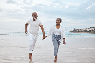 Buy stock photo Shot of a mature couple spending time at the beach