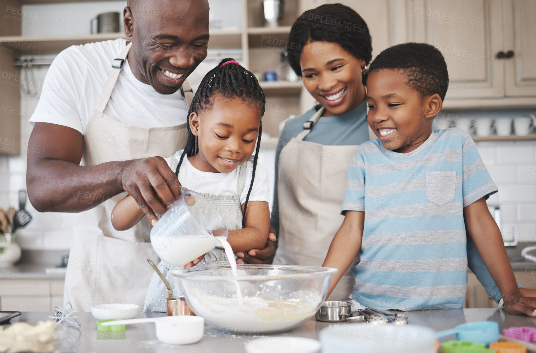 Buy stock photo Shot of a family baking together in the kitchen