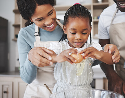 Buy stock photo Shot of a couple baking with their daughter at home