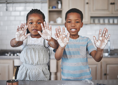 Buy stock photo Shot of a little girl and boy having fun while baking together at home