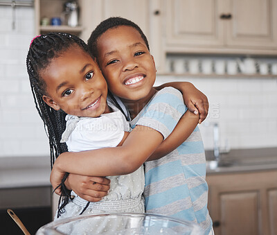 Buy stock photo Shot of an adorable little girl bonding with her brother at home while baking