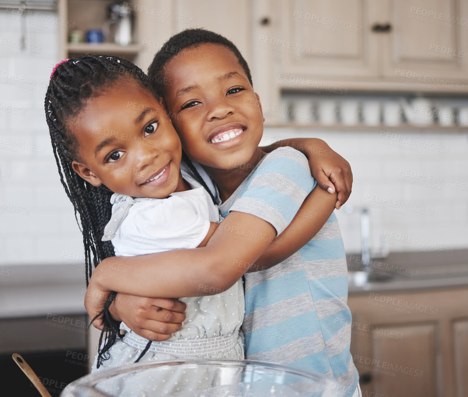 Buy stock photo Shot of an adorable little girl bonding with her brother at home while baking