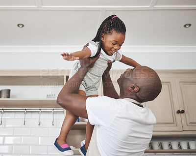 Buy stock photo Shot of a man lifting his adorable little daughter in the air